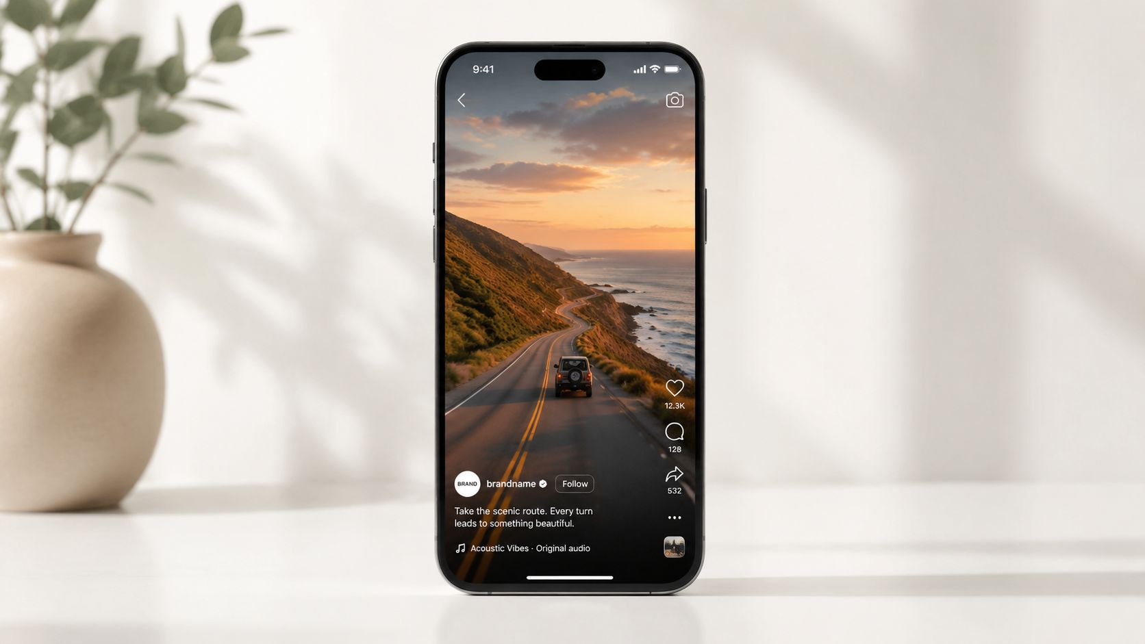 A smartphone screen displaying a scenic coastal road trip video on a social media app feed.