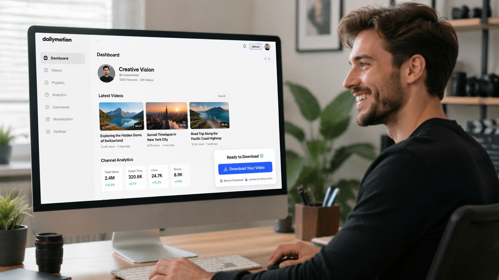 A man smiling at his computer monitor displaying a Dailymotion dashboard for video management and channel analytics.
